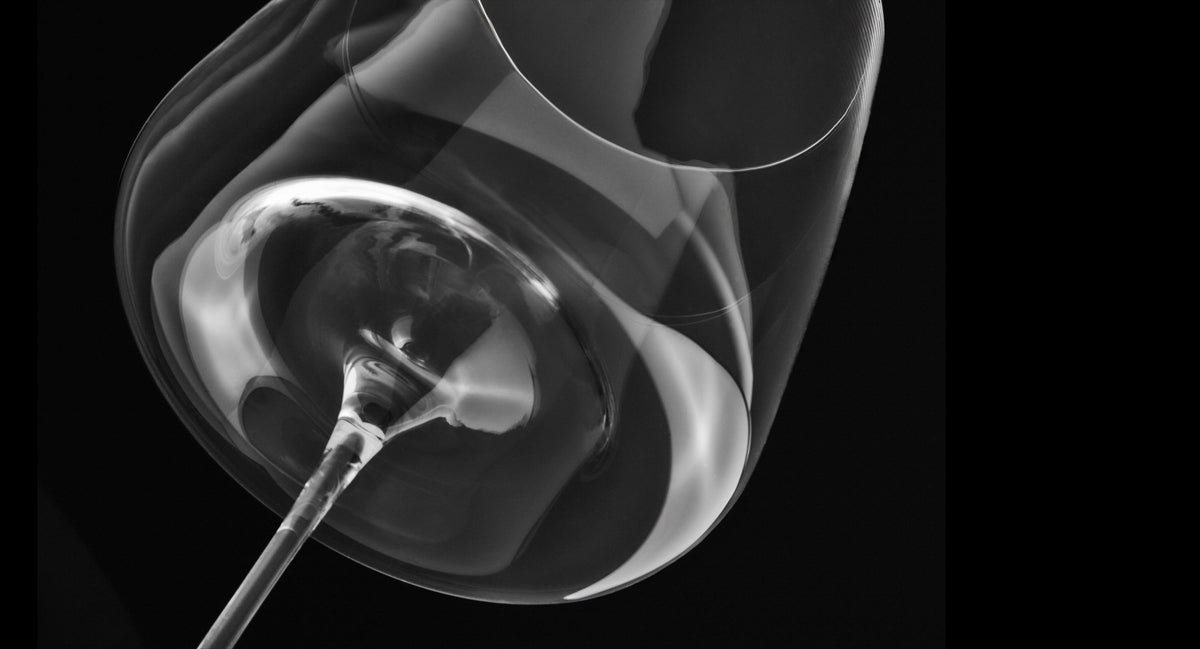 Black and white X-ray of a human ear with a spoon inside on a black background